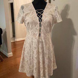 Cream lace mini dress. Laces up front
